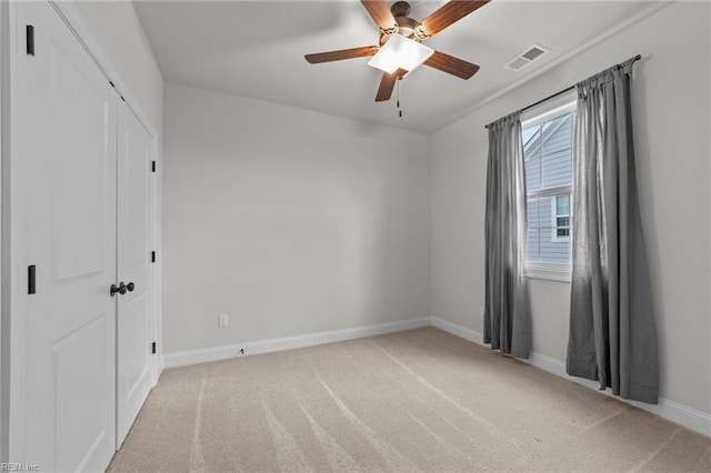 carpeted empty room with ceiling fan