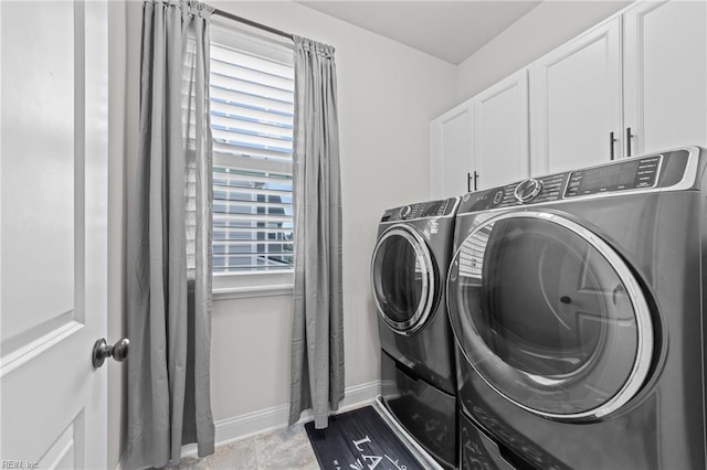 laundry area featuring cabinets and washing machine and clothes dryer