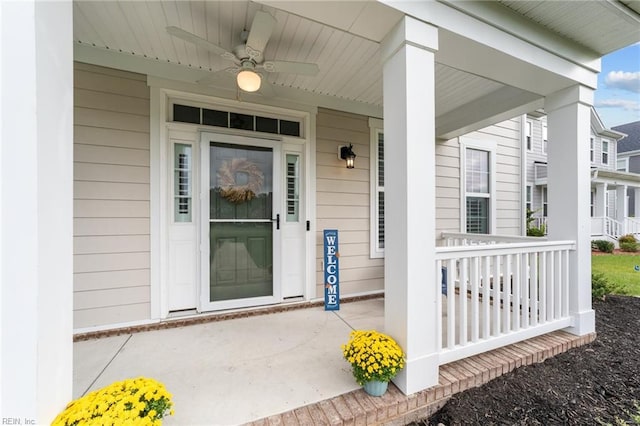 entrance to property with a porch and ceiling fan