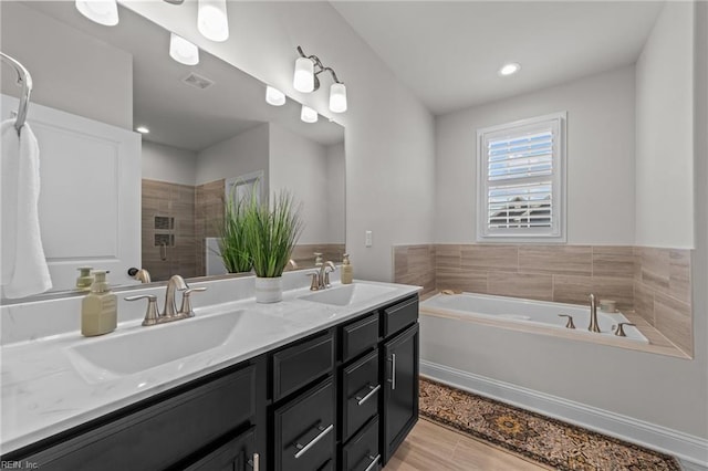 bathroom with shower with separate bathtub, vanity, and hardwood / wood-style flooring