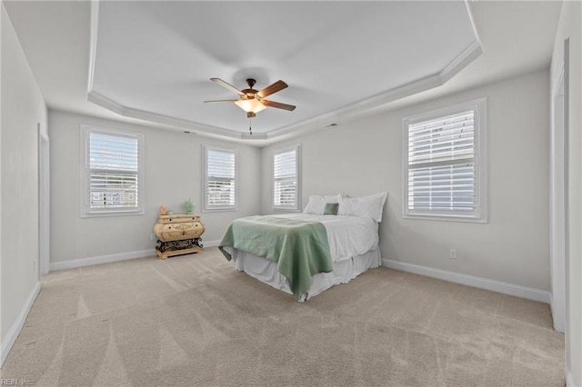 unfurnished bedroom featuring light carpet, a raised ceiling, and ceiling fan