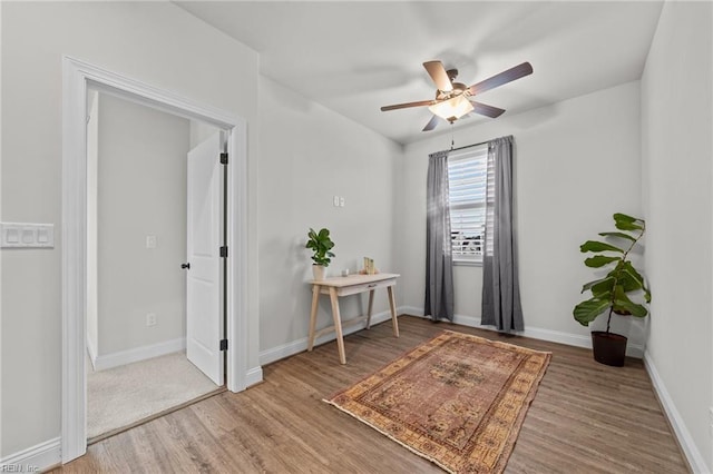 foyer entrance with ceiling fan and light hardwood / wood-style flooring