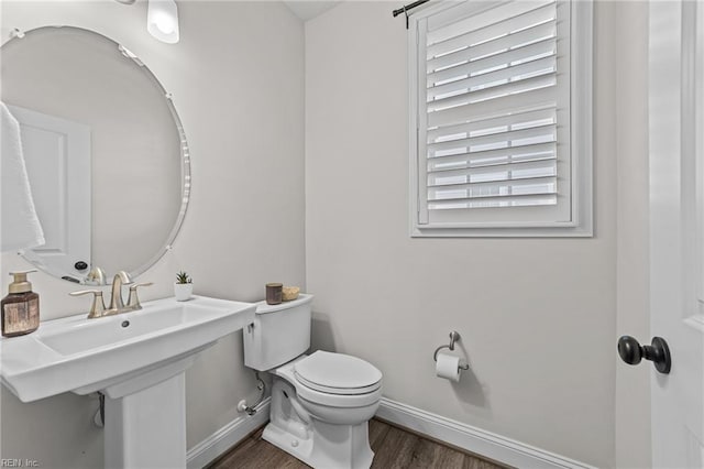 bathroom with sink, hardwood / wood-style floors, and toilet