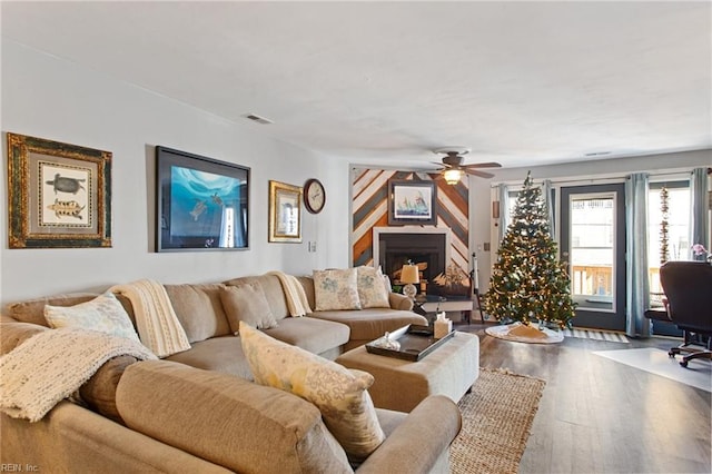 living room with ceiling fan and hardwood / wood-style floors