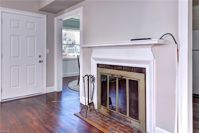 unfurnished living room featuring dark hardwood / wood-style flooring and a fireplace