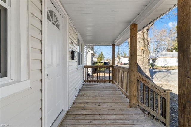 wooden terrace featuring covered porch