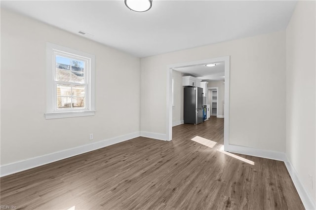 empty room featuring dark hardwood / wood-style flooring