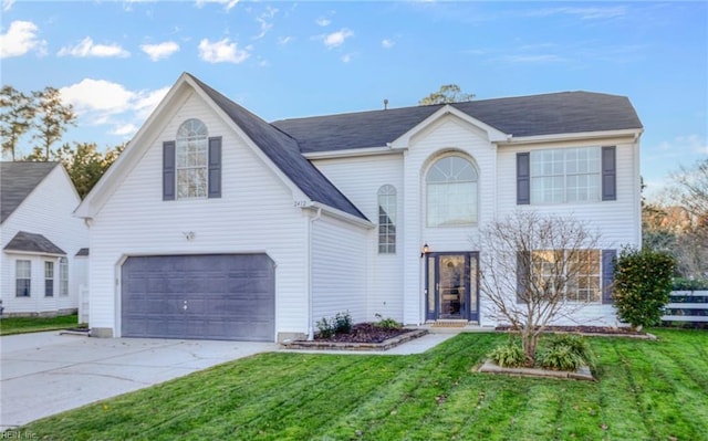 view of front of property with a front lawn and a garage