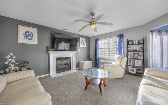 carpeted living room with ceiling fan