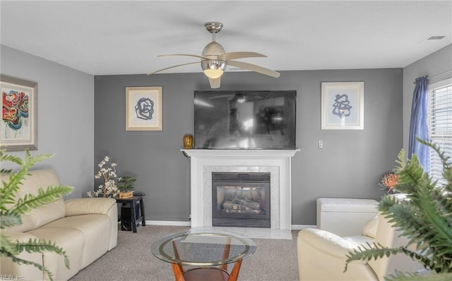 carpeted living room featuring ceiling fan