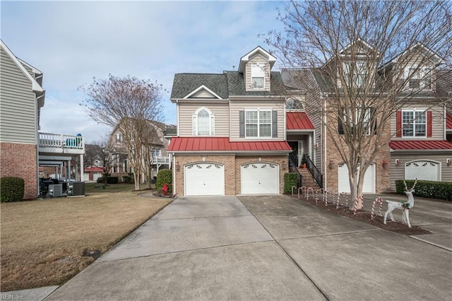 view of front of house with a garage and central AC