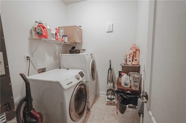 clothes washing area featuring washing machine and dryer and light tile patterned flooring