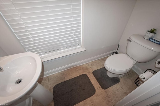 bathroom featuring tile patterned flooring, toilet, and sink