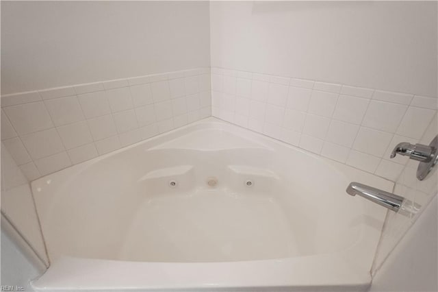 bathroom with tiled bath