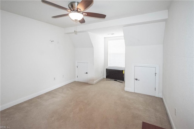 carpeted empty room featuring ceiling fan and lofted ceiling