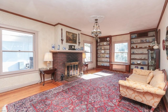 living room with wood-type flooring, a fireplace, and ornamental molding