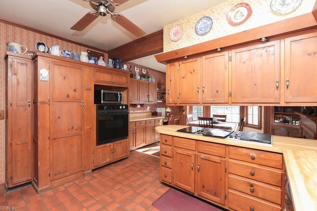 kitchen featuring butcher block counters, ceiling fan, dark tile patterned floors, and oven