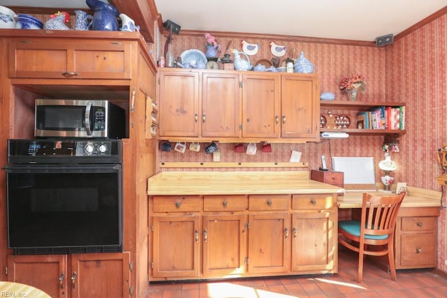 kitchen with butcher block countertops, oven, light tile patterned floors, and crown molding