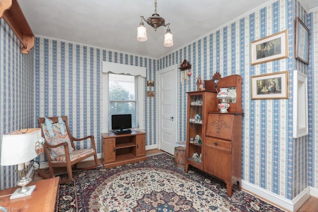 sitting room featuring hardwood / wood-style flooring and ornamental molding