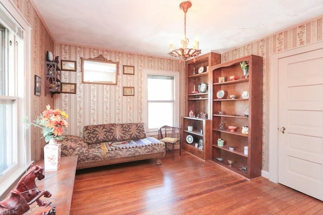 living area with a chandelier and wood-type flooring