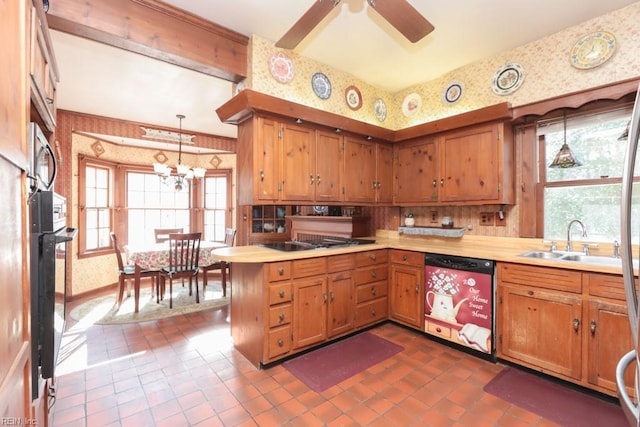 kitchen with kitchen peninsula, sink, hanging light fixtures, and black appliances