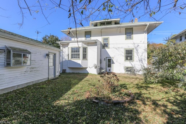 rear view of house with a yard