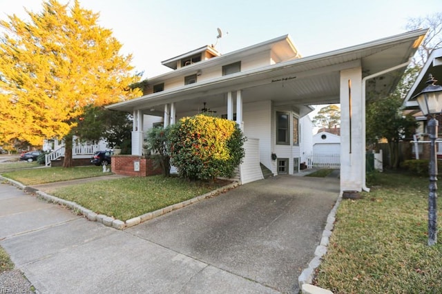 view of front of property with a front yard and a carport