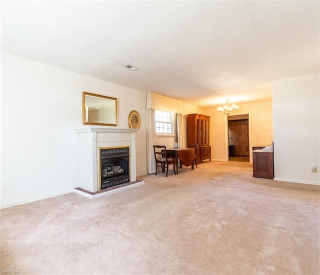 unfurnished living room featuring light colored carpet and a notable chandelier