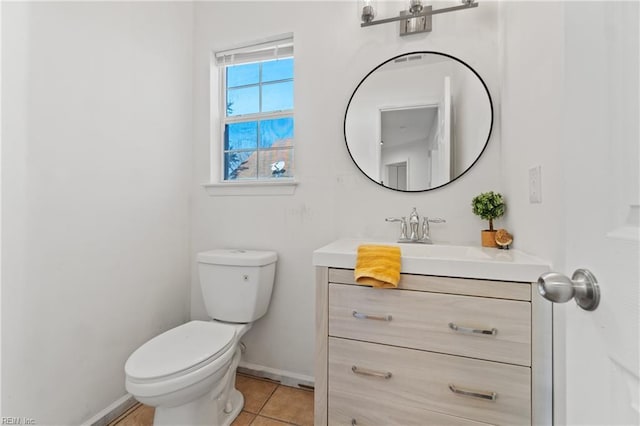 bathroom featuring tile patterned flooring, vanity, and toilet