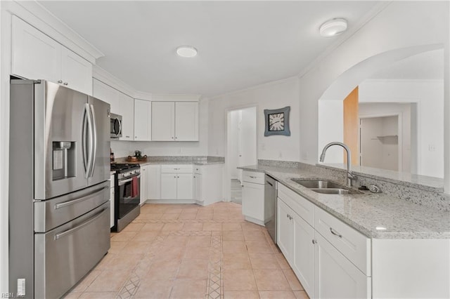 kitchen with white cabinets, light stone counters, kitchen peninsula, and appliances with stainless steel finishes