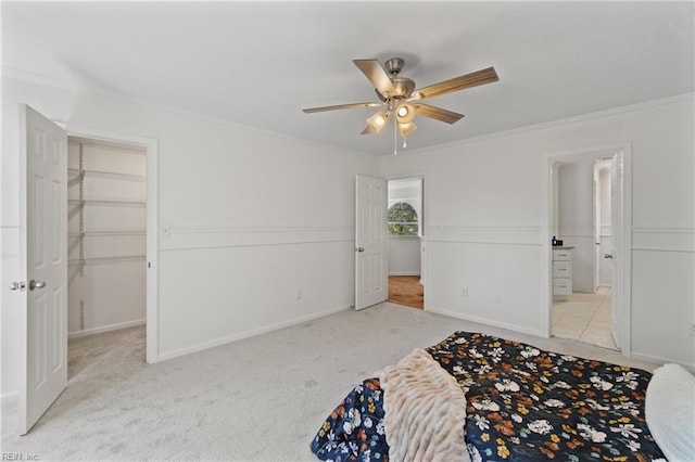 unfurnished bedroom featuring ceiling fan, light colored carpet, and ornamental molding