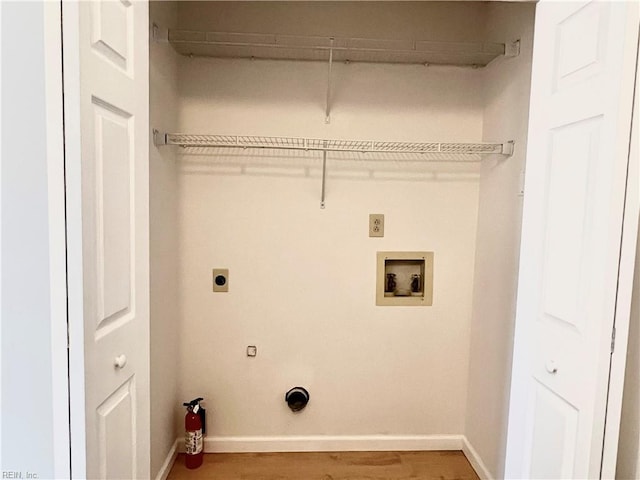 laundry room with electric dryer hookup, gas dryer hookup, hardwood / wood-style floors, and washer hookup