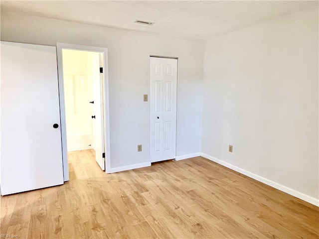 unfurnished bedroom with light wood-type flooring