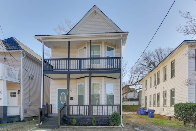 view of front facade with a balcony and a porch