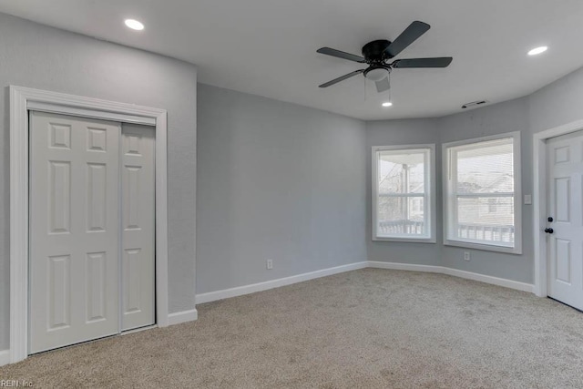 interior space featuring light carpet and ceiling fan