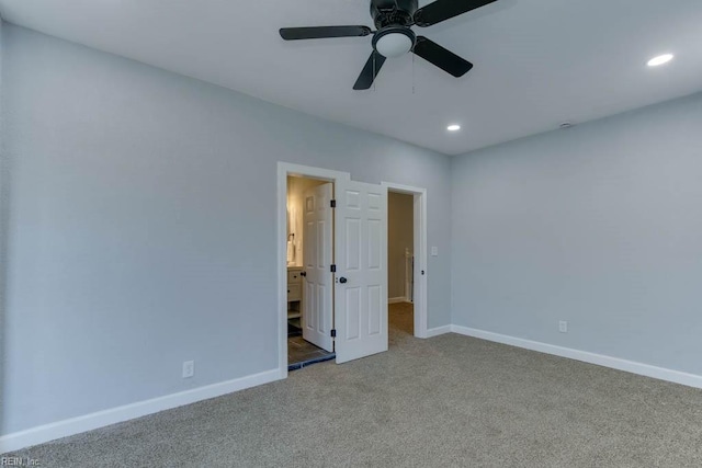 unfurnished bedroom featuring carpet, connected bathroom, and ceiling fan