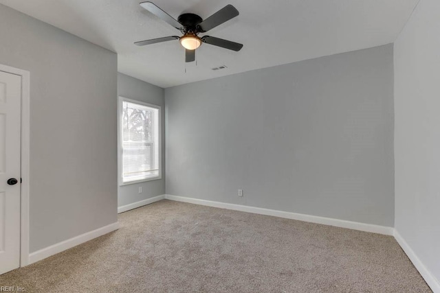 empty room with ceiling fan and light colored carpet