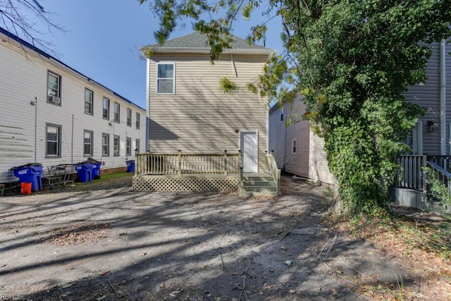 back of property featuring a wooden deck