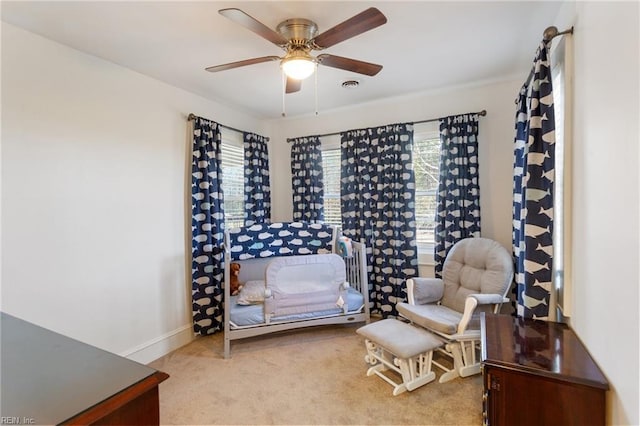 living area featuring light carpet and ceiling fan