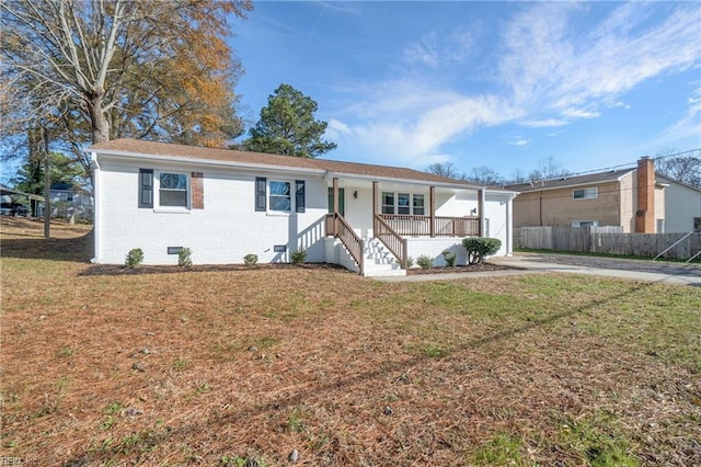 single story home featuring covered porch and a front yard