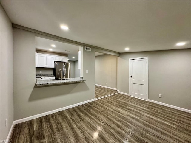 unfurnished living room with dark hardwood / wood-style flooring and sink