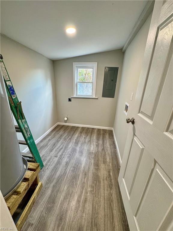 washroom featuring washer hookup, electric panel, and dark hardwood / wood-style floors