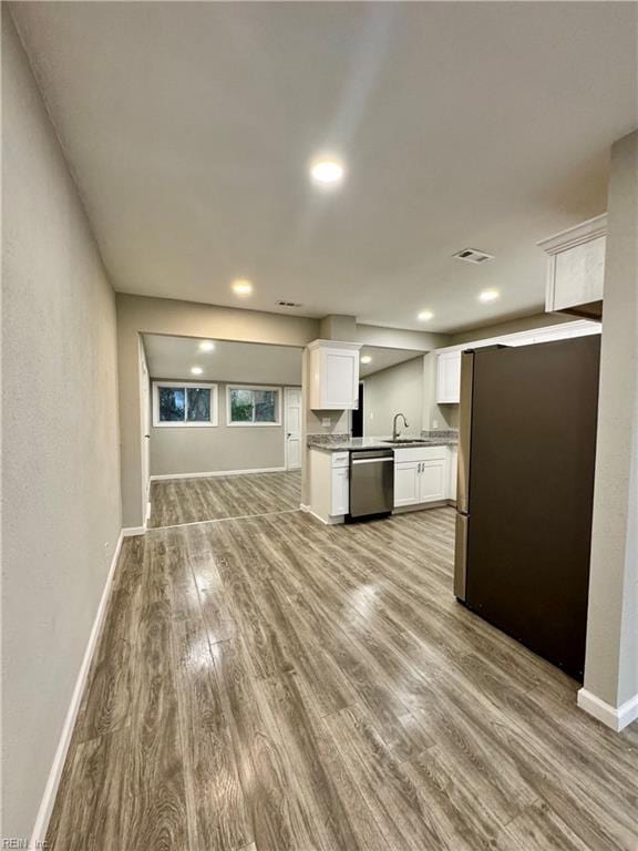 unfurnished living room featuring light hardwood / wood-style floors and sink