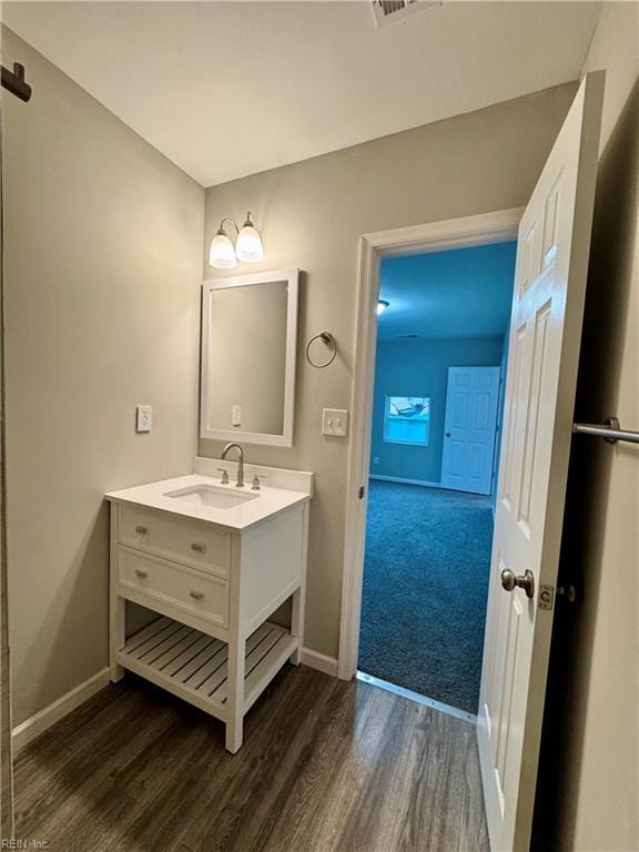 bathroom with hardwood / wood-style floors and vanity