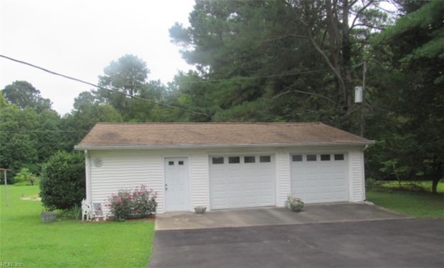 garage featuring a lawn