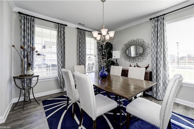 dining area featuring dark hardwood / wood-style flooring, crown molding, and a wealth of natural light