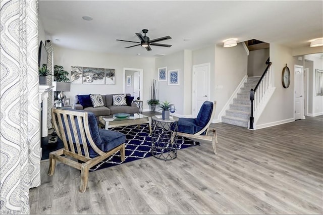 living room featuring wood-type flooring and ceiling fan