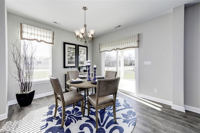 dining room featuring dark wood-type flooring and a notable chandelier