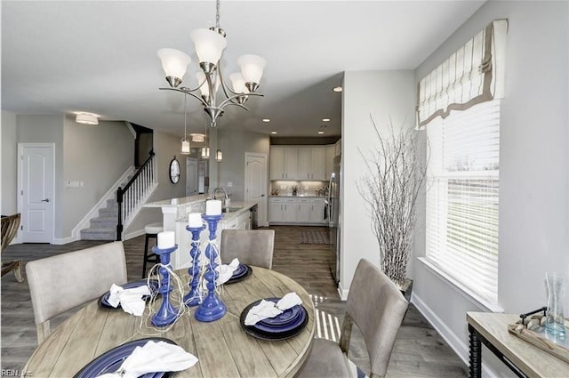 dining area with a chandelier and dark hardwood / wood-style flooring