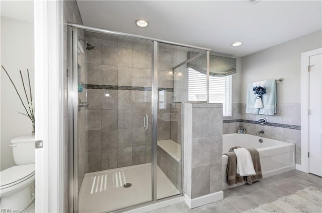 bathroom with plus walk in shower, tile patterned floors, and toilet